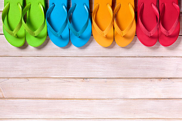 istock Row of flip flops on beach wood decking 538184042