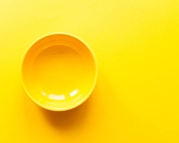 istock Yellow bowl or plate on yellow table. Top view 538184142