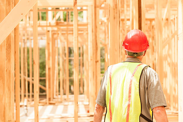istock Construction worker busy working at job site. Framed building. 538184602