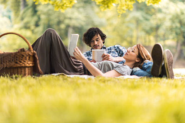istock Young couple relaxing with books on picnic during springtime. 538188802