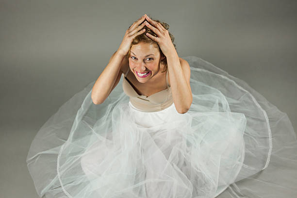 High angle beautiful young ballerina sit in the floor stock photo