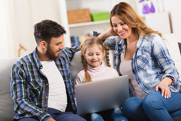 istock Young loving family using laptop at home. 538189224