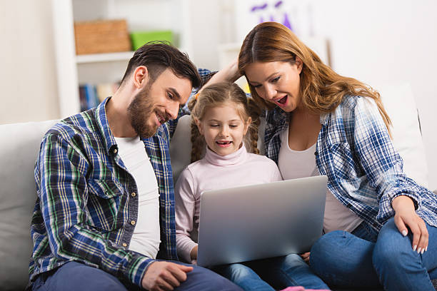 istock Young loving family enjoying watching something surprising on laptop. 538189338