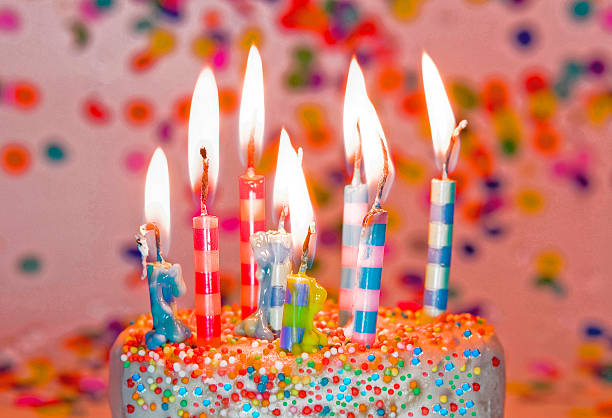 istock Birthday cake with colorful burning birthday candles 538189462