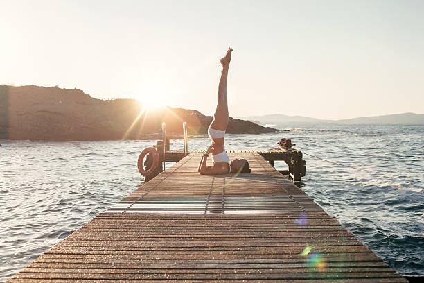 istock Girl practicing yoga at the quay 538191514