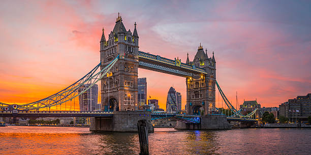 London Tower Bridge City skyscrapers illuminated Thames golden sunset UK Dramatic sunset skies above the iconic span of Tower Bridge framing the futuristic skyscrapers of the Square Mile financial district above the slow moving waters of the River Thames in the heart of London, Britain's vibrant capital city. ProPhoto RGB profile for maximum color fidelity and gamut. 122 leadenhall street photos stock pictures, royalty-free photos & images