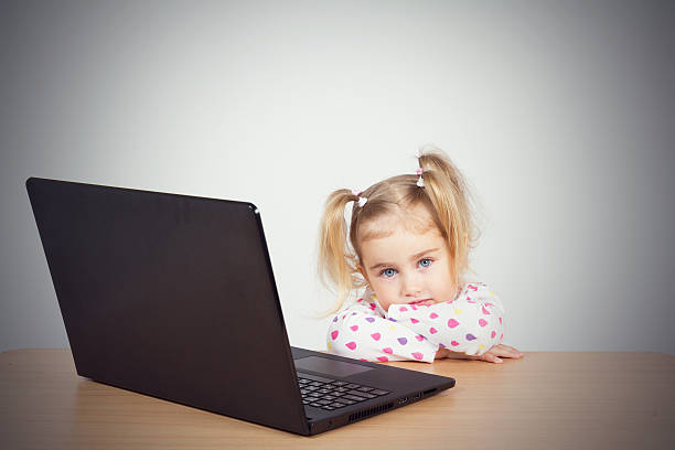 istock little girl at the computer. 538195410