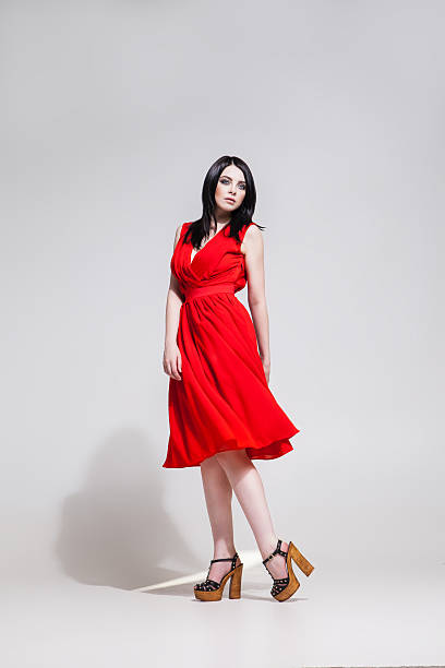 istock Studio shot of black-haired model in red dress 538196168