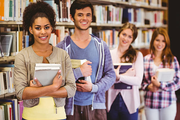 istock Happy students holding books in row 538202327
