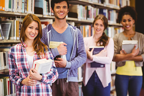 istock Happy students holding books in row 538202333