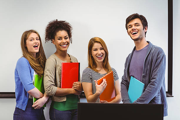 istock Students standing and smiling at camera holding notepads 538202719