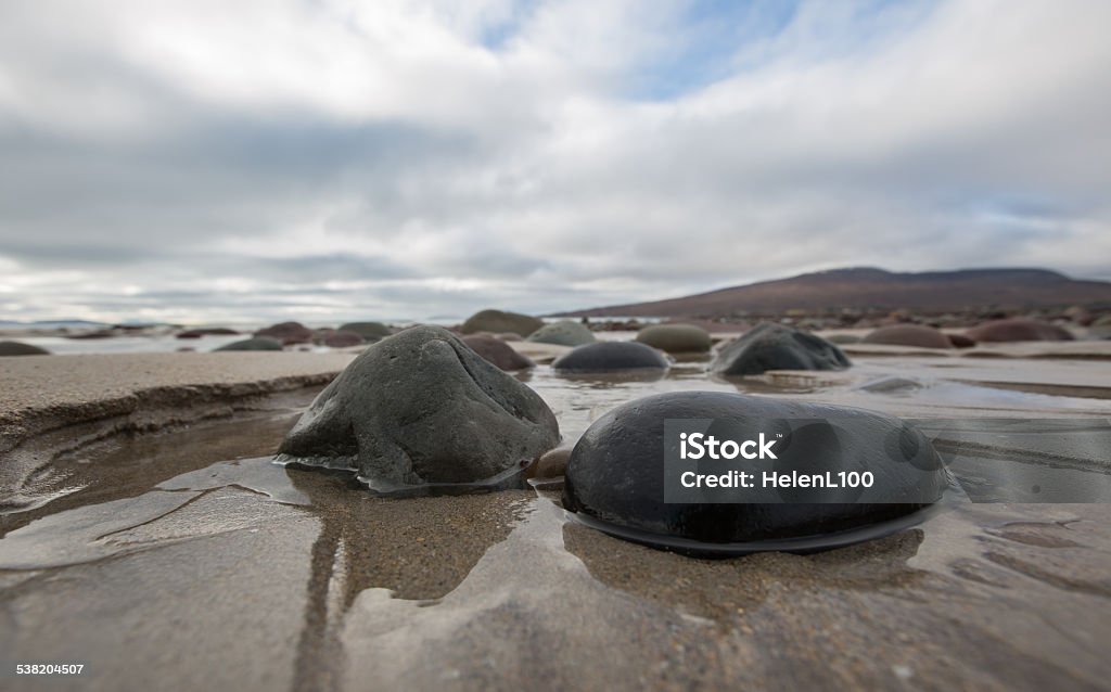 Pebbles on wet sandy beach Close up of pebbles on a sandy beach in County Mayo, Ireland. 2015 Stock Photo