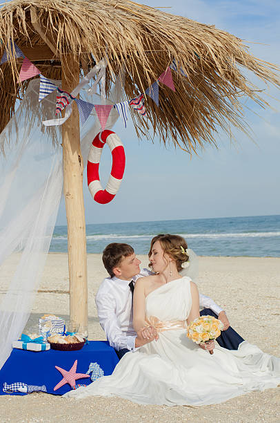 Young bride and groom on the beach stock photo