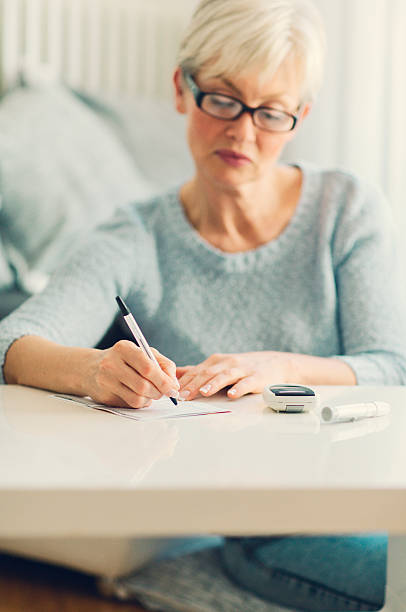 istock Mature Woman Doing Blood Sugar Test at home. 538206785