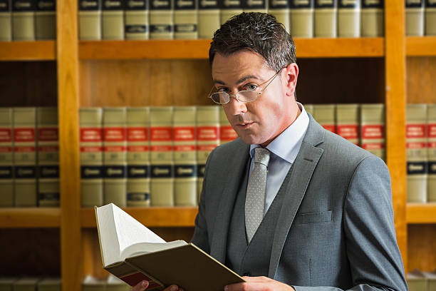 istock Lawyer reading book in the law library 538235131