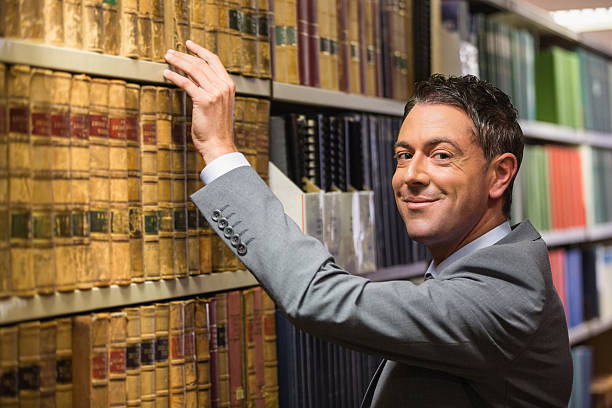 istock Lawyer picking book in the law library 538235655
