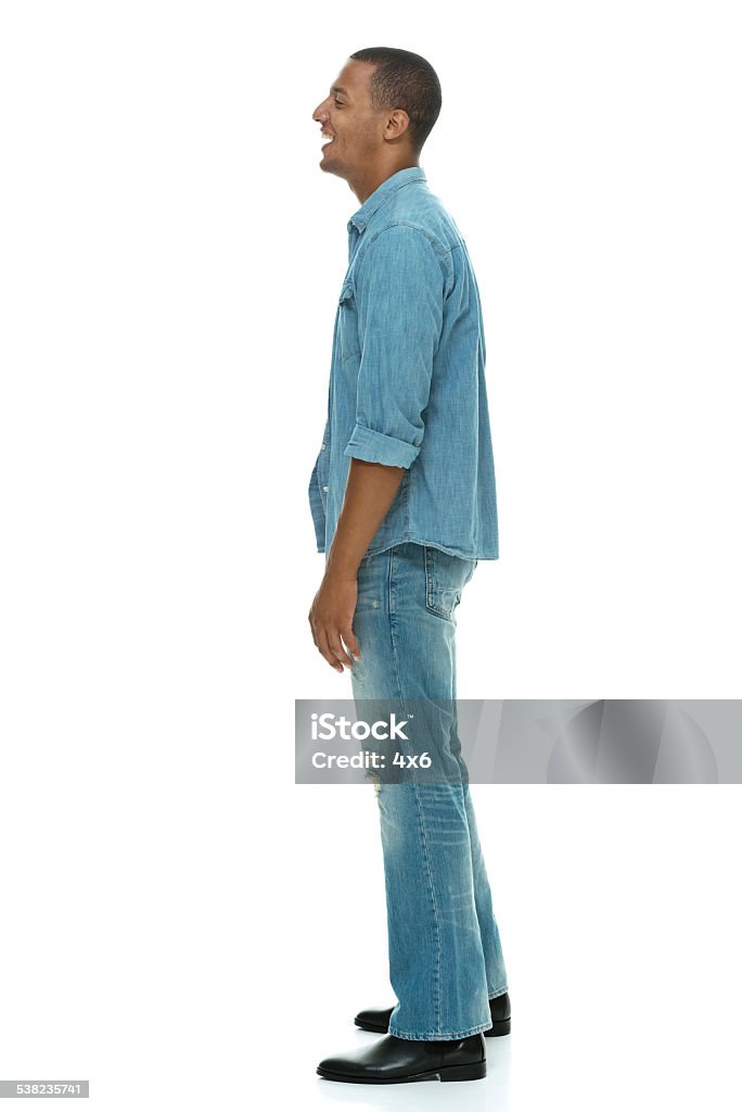 Side view of happy young man standing Side view of happy young man standinghttp://www.twodozendesign.info/i/1.png Full Length Stock Photo