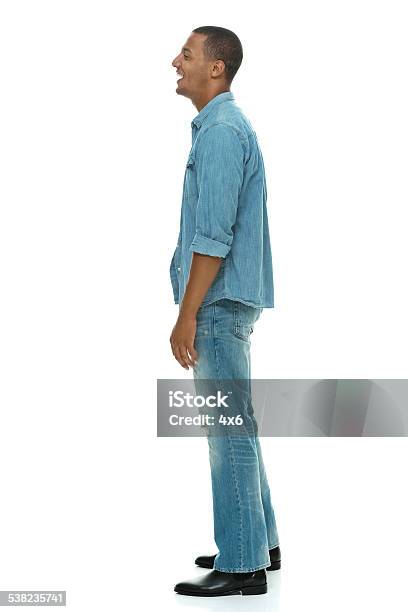 Side View Of Happy Young Man Standing Stock Photo - Download Image Now - Full Length, African Ethnicity, Men