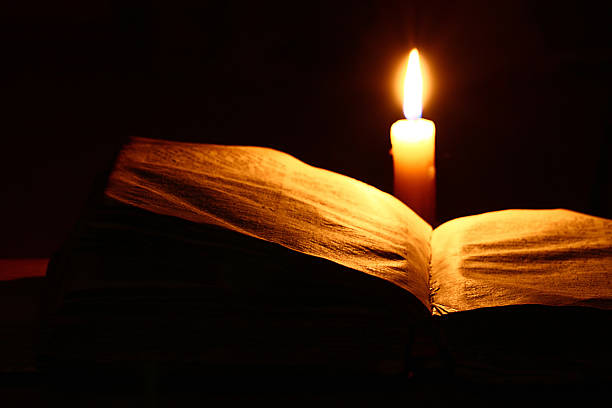 istock concept of knowledge, vintage book candle 538239205