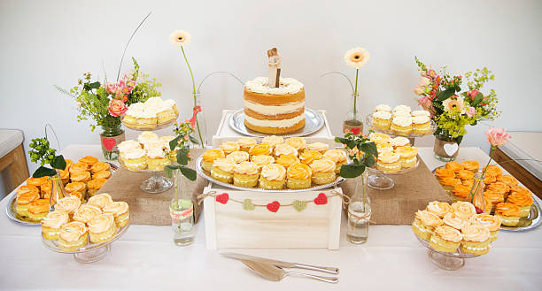 Wedding cake and cup cakes stock photo