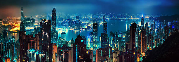 panorama of evening hong kong wide panorama of evening hong kong hong kong business district stock pictures, royalty-free photos & images