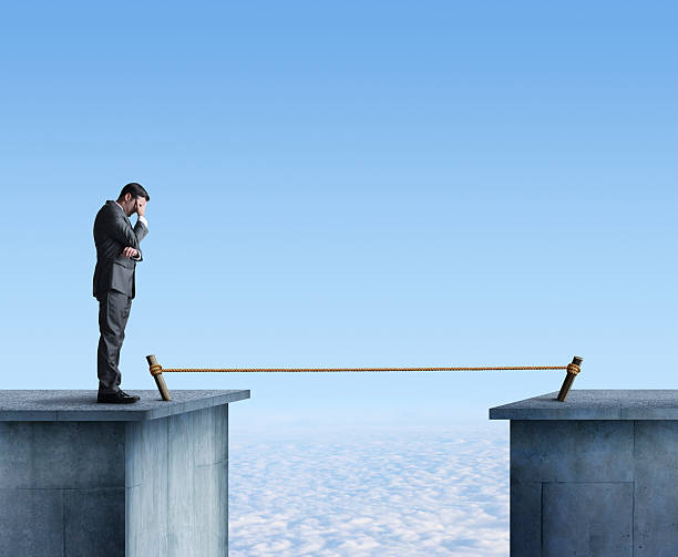 istock Businessman Contemplating Having To Cross A Tightrope 538260057