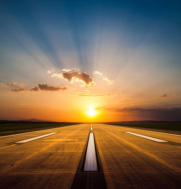 Airport runway at sunset stock photo