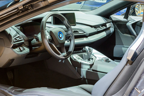 Brussels, Belgium - January 15, 2015: BWW i8 Hybrid sports car interior on display during the 2015 Brussels motor show. People in the background are looking at the cars.