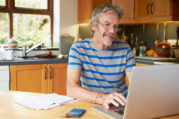 istock Mature Man Looking At Home Finances In Kitchen 538262721