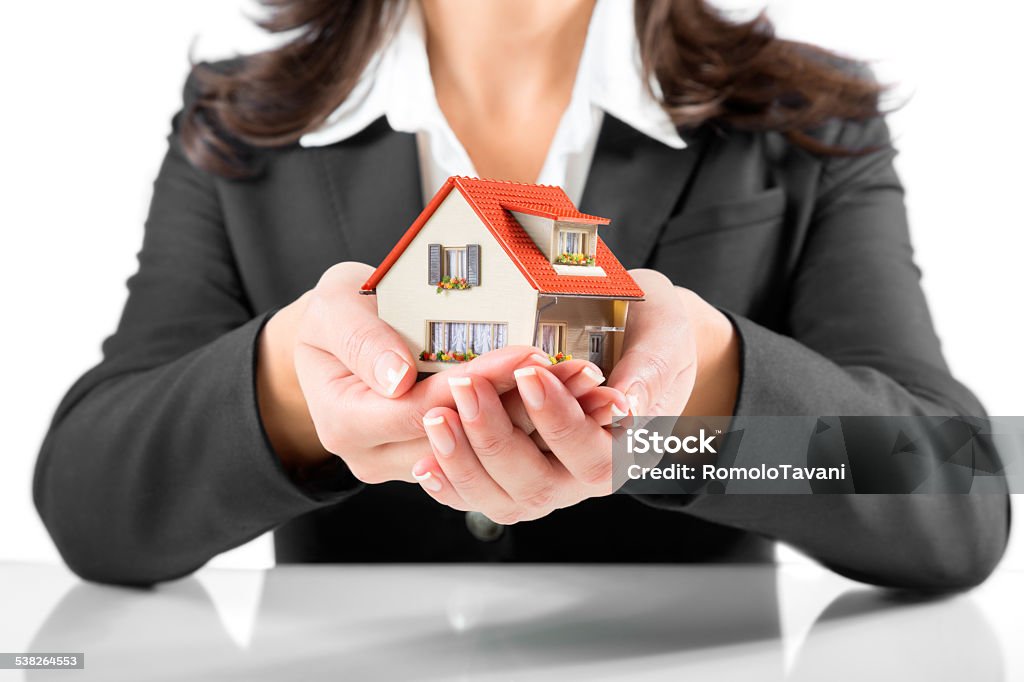 Real Estate Agent gives home insurance and protection concept - woman gives house 2015 Stock Photo