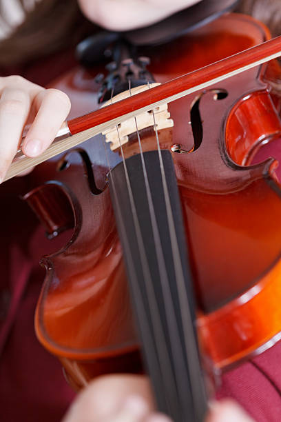 istock girl playing violin at concert 538264677