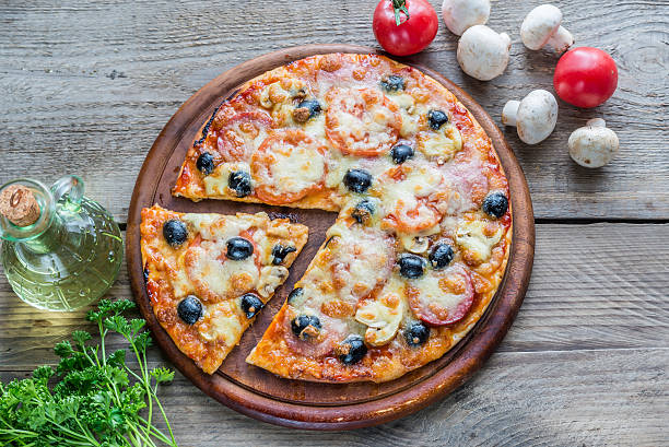 Cooked pizza on the wooden board