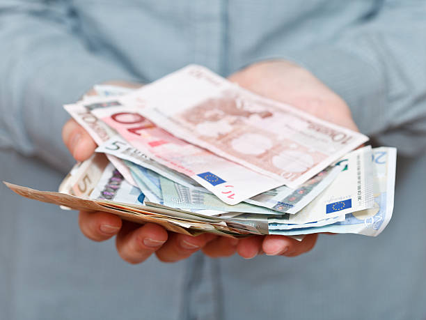 istock many euro banknotes in cupped palms 538279709