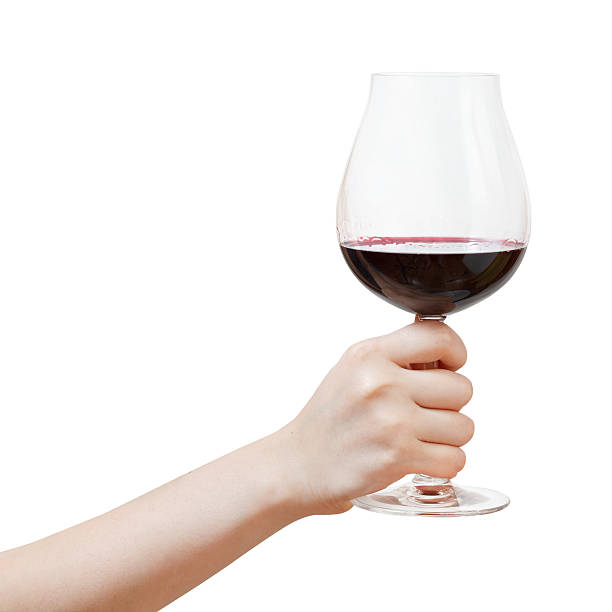 hand rises big glass with red wine