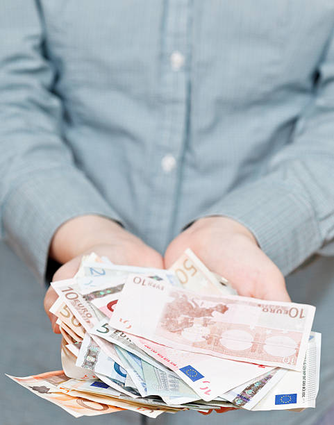 istock lot of euro banknotes in cupped palms 538280055