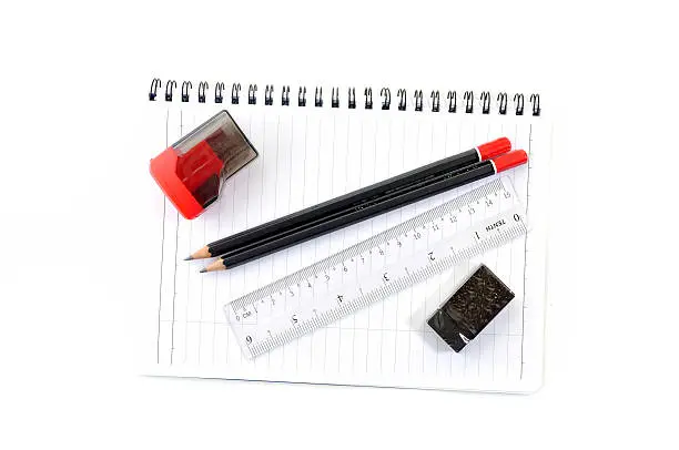 Blank page with pencils, eraser, ruler and sharpener isolated on white background
