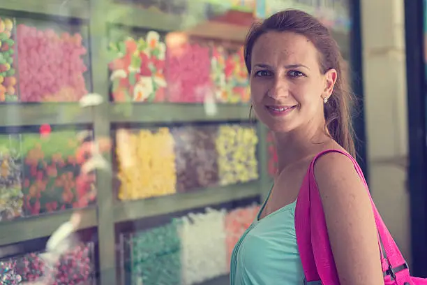 Woman admireing different candys through shop window