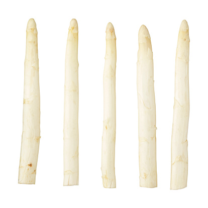 Five white asparagus spears on a white background.