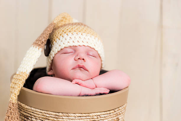istock Goreous sleeping Caucasian newborn with knitted wool hat in basket 538321317