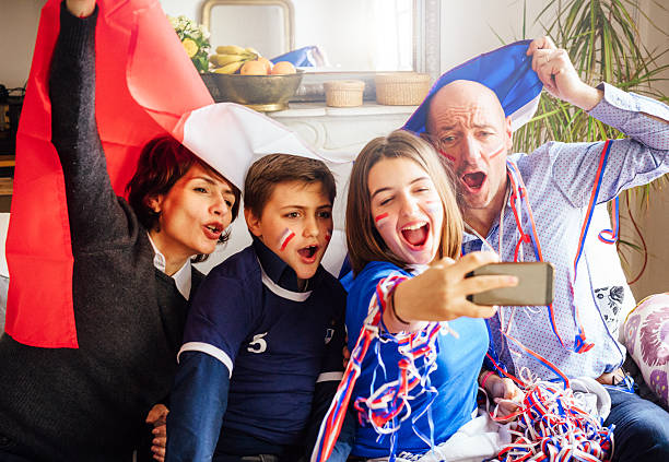 istock french family posing for fan selfie 538322640