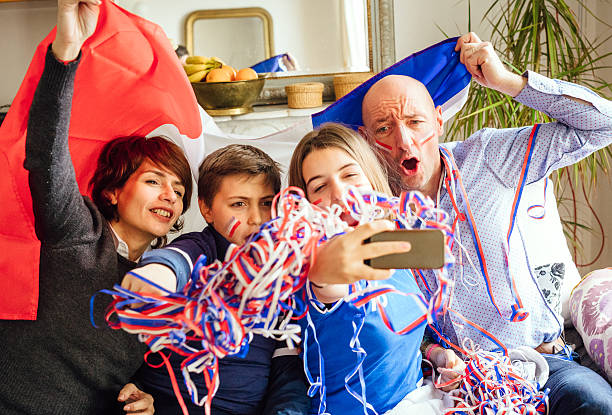 istock french family posing for fan selfie 538322840
