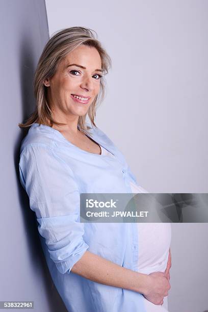 Beautiful Blonde Mature Pregnant Woman Blue Shirt Isolated Gray Background Stock Photo - Download Image Now