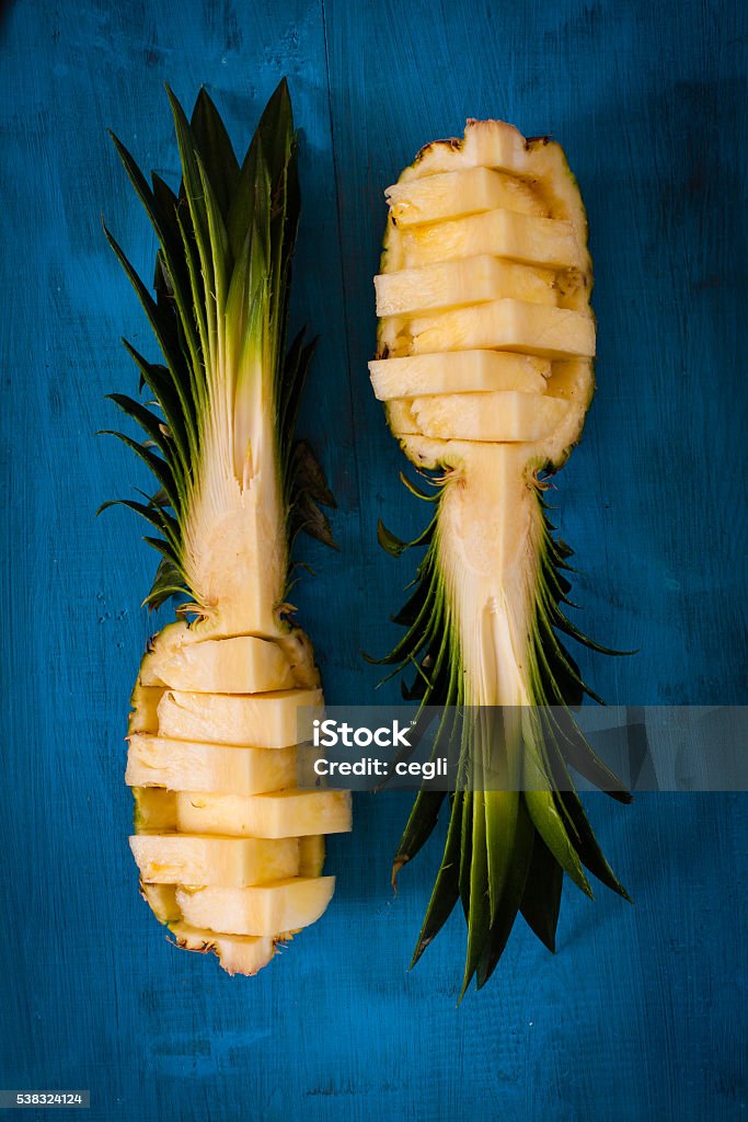 Pineapple pieces lying on wooden board. Backgrounds Stock Photo