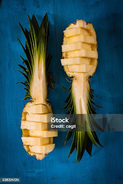 Pineapple Pieces Lying On Wooden Board Stock Photo - Download Image Now - Backgrounds, Blue, Close-up