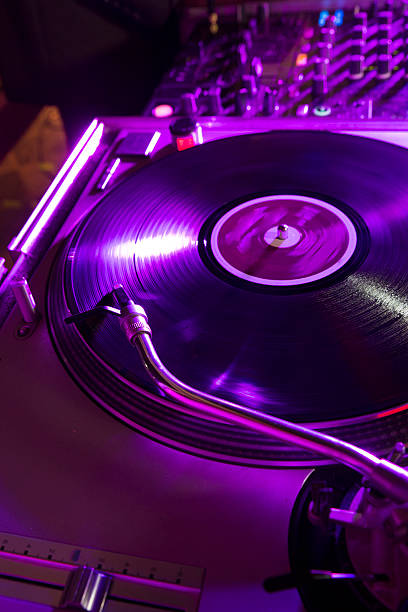 Spinning  vinyl on the decks Vinyl record, spinning on the dj decks in a nightclub. dubstep photos stock pictures, royalty-free photos & images