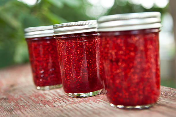 Three jars of home made raspberry jam.
