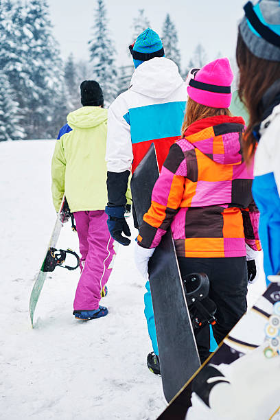 istock Climbing to mountain peak with snowboards 538326129