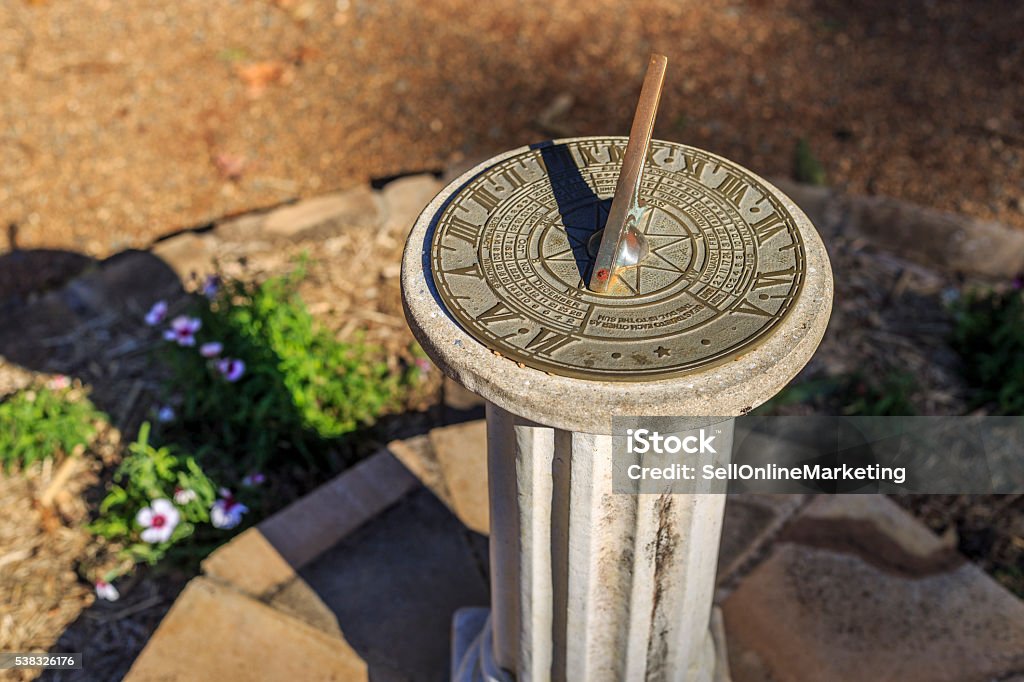 Sundial in the botanical gardens. A sundial telling the time. Sundial Stock Photo