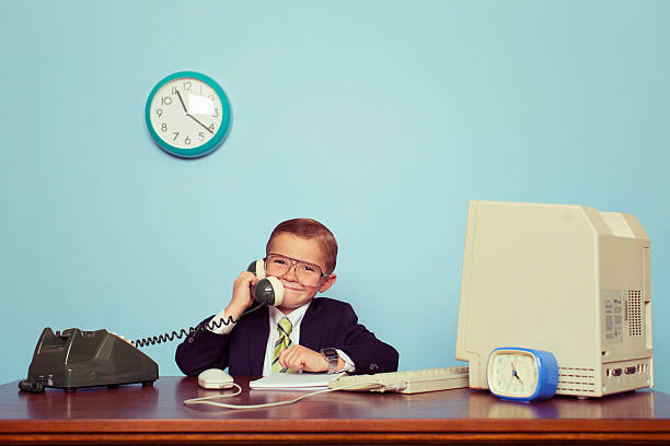 istock Young Boy Businessman Talks on the Telephone 538326331