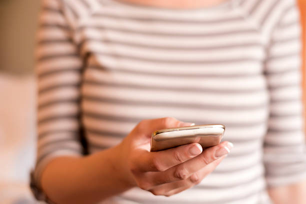 istock Woman sending message on her smart phone 538326356